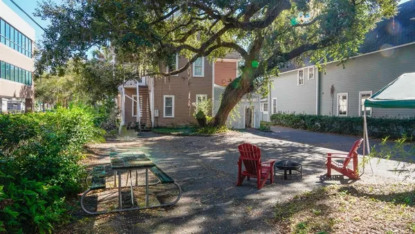 a view of a house with backyard porch and sitting area