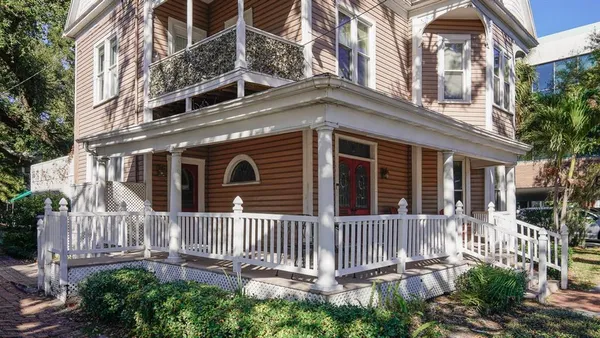 a front view of a house with a fence