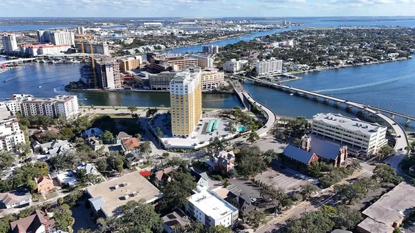 a view of an empty room with window and fireplace