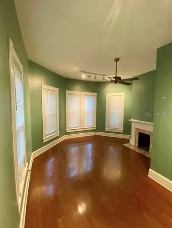 a view of a livingroom with a fireplace and fan