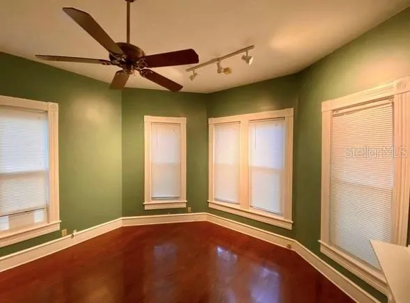 a view of an empty room with a fireplace and a window