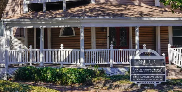 a view of a house with wooden fence
