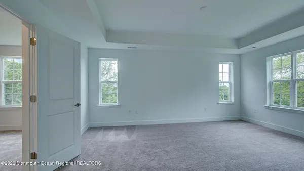 an empty room with windows and closet