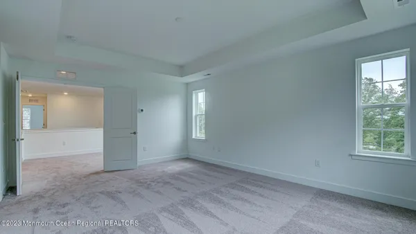 an empty room with windows and closet
