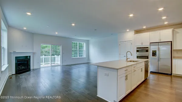 a kitchen with a refrigerator and a stove top oven