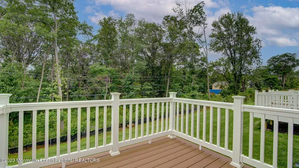 a large kitchen with stainless steel appliances kitchen island a large counter top and a wooden floors