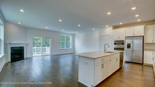 a kitchen with a sink stainless steel appliances and window