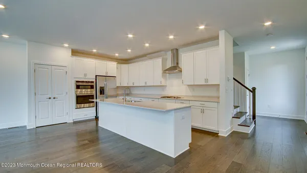 a kitchen with stainless steel appliances a stove refrigerator sink and microwave