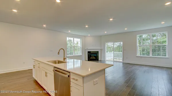 a kitchen with granite countertop a sink and a stove top oven