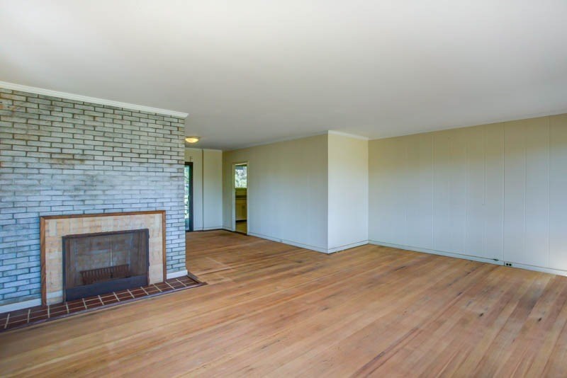 8595 Elepaio Road Kekaha, HI 96752 - Photo 11 of 25 a view of empty room with wooden floor and fireplace
