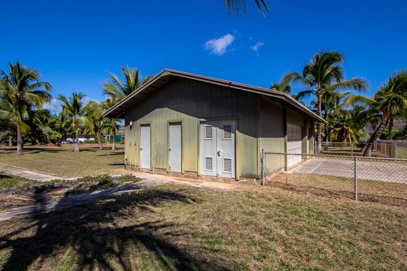 8595 Elepaio Road Kekaha, HI 96752 - Photo 23 of 25 a large house with tree in front of it