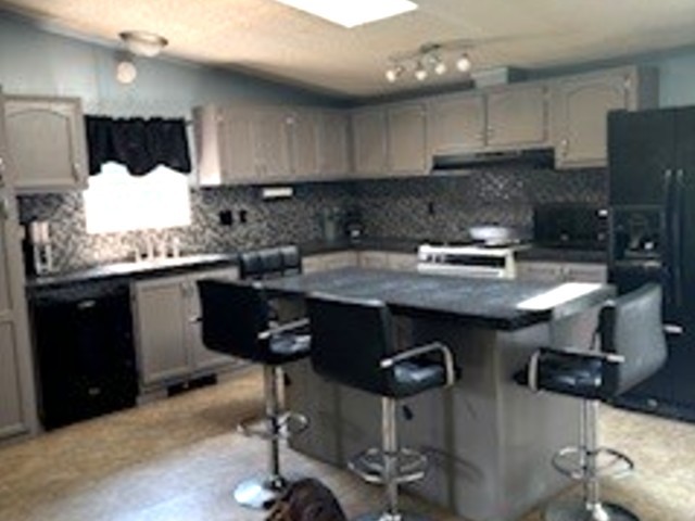 3490 South Dwight Road Mazon, IL 60444 - Photo 6 of 17 a kitchen with granite countertop a sink a stove a refrigerator and chairs