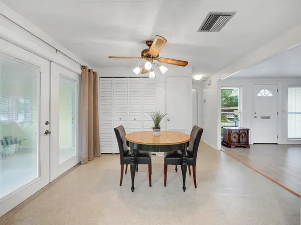a view of a dining room with furniture and chandelier