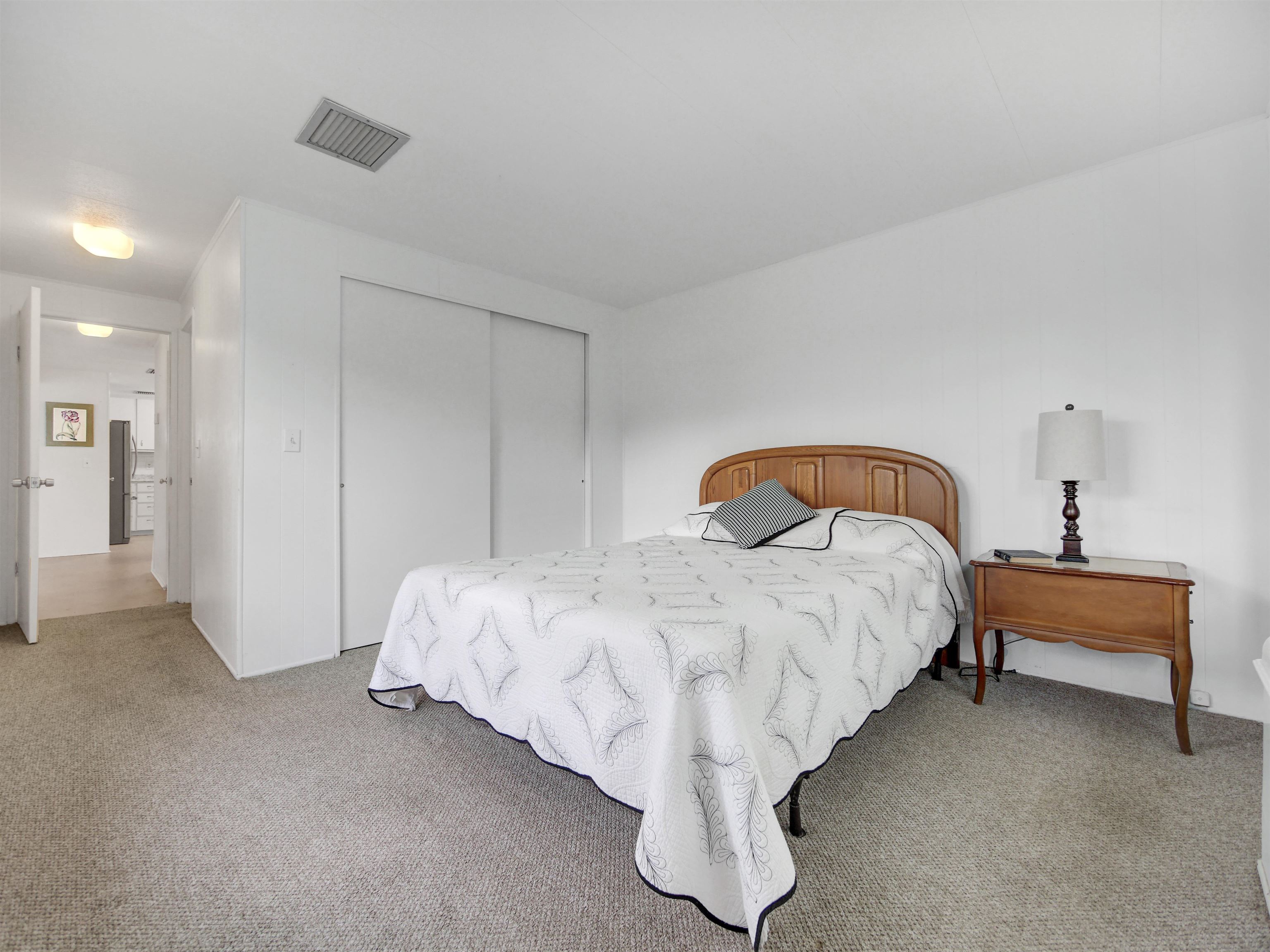 879 Palermo Road St. Augustine, FL 32086 - Photo 13 of 38 a bed sitting in a bedroom next to a lamp