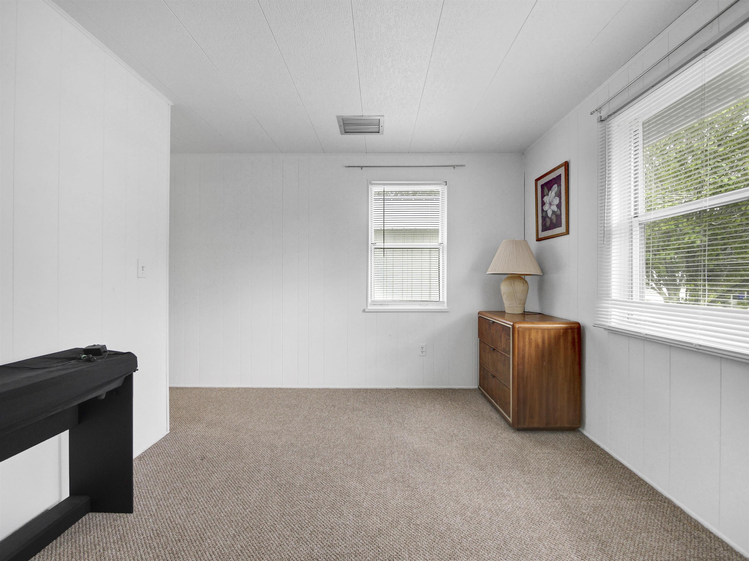 879 Palermo Road St. Augustine, FL 32086 - Photo 17 of 38 a room with a window and a dresser