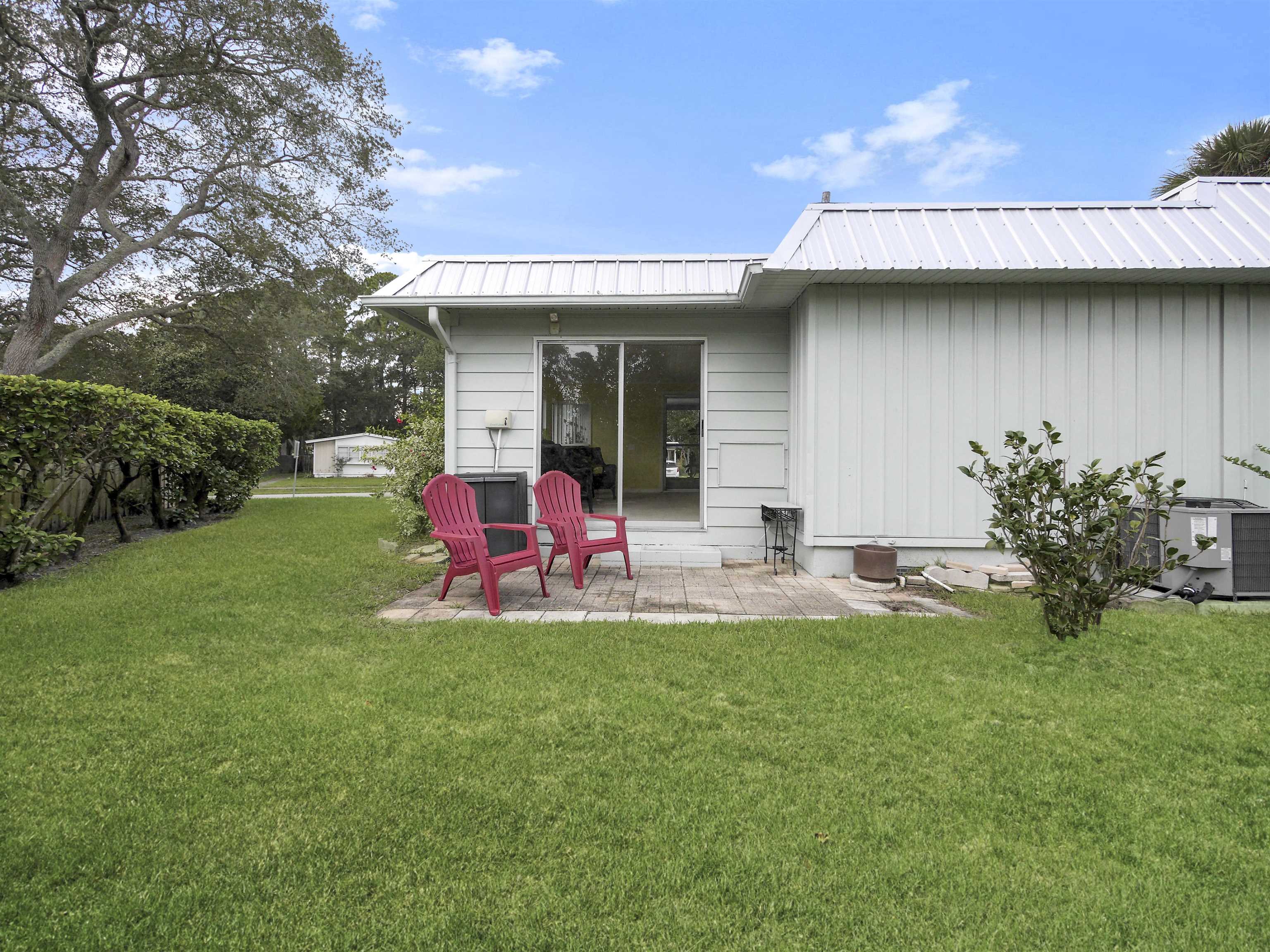 879 Palermo Road St. Augustine, FL 32086 - Photo 26 of 38 a view of a house with backyard sitting area and garden