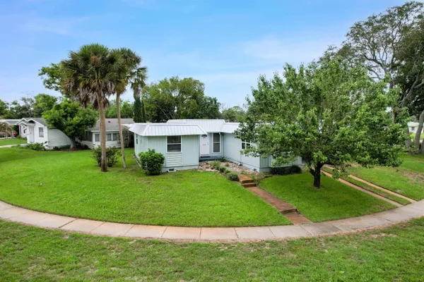 a view of a house with a yard porch and sitting area