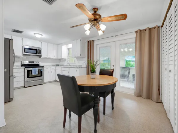 a view of a dining room with furniture and a chandelier
