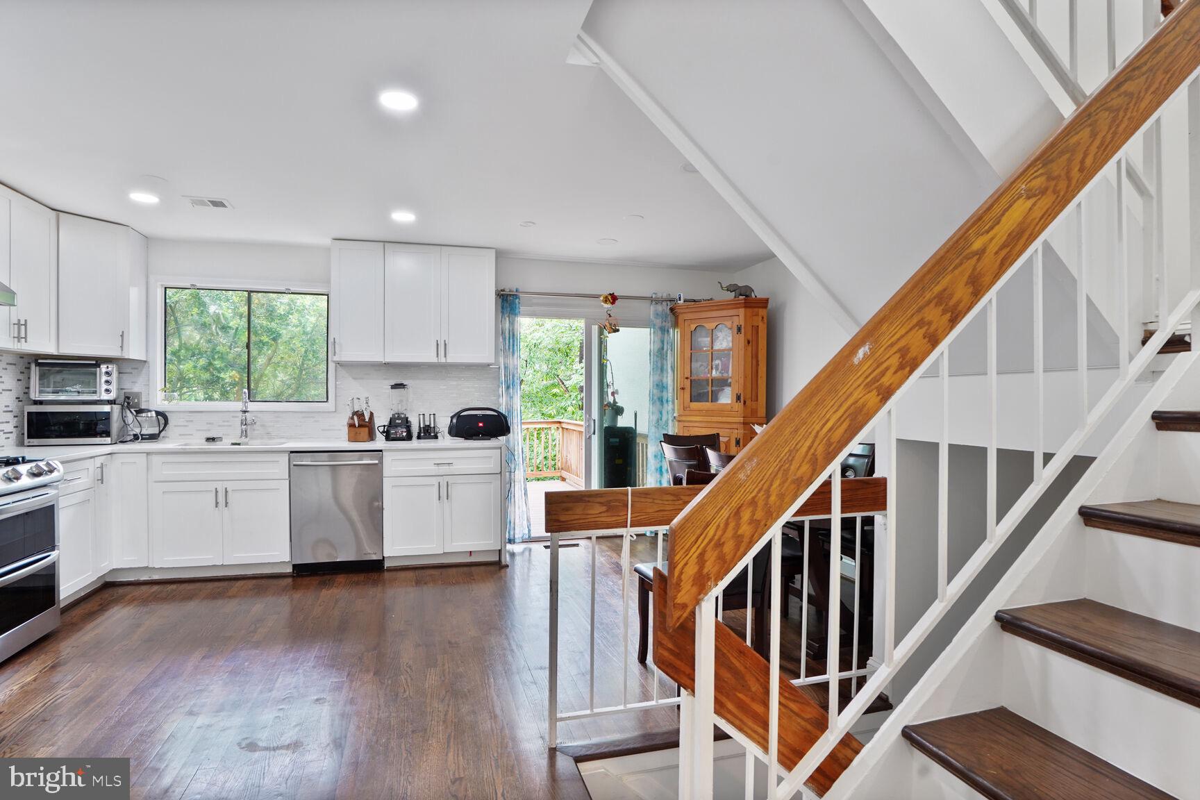 2412 Southgate Square Reston, VA 20191 - Photo 11 of 34 a kitchen with cabinets a sink and white appliances