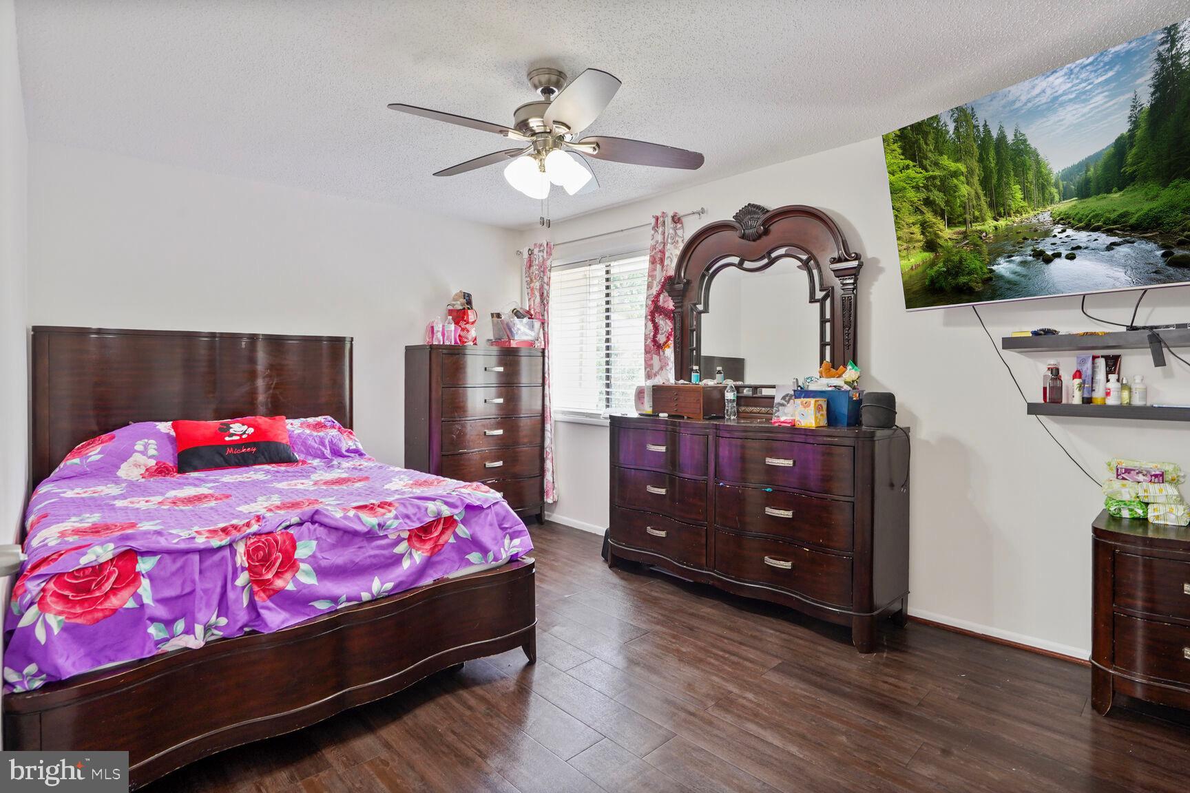 2412 Southgate Square Reston, VA 20191 - Photo 16 of 34 a bedroom with a bed and a chandelier