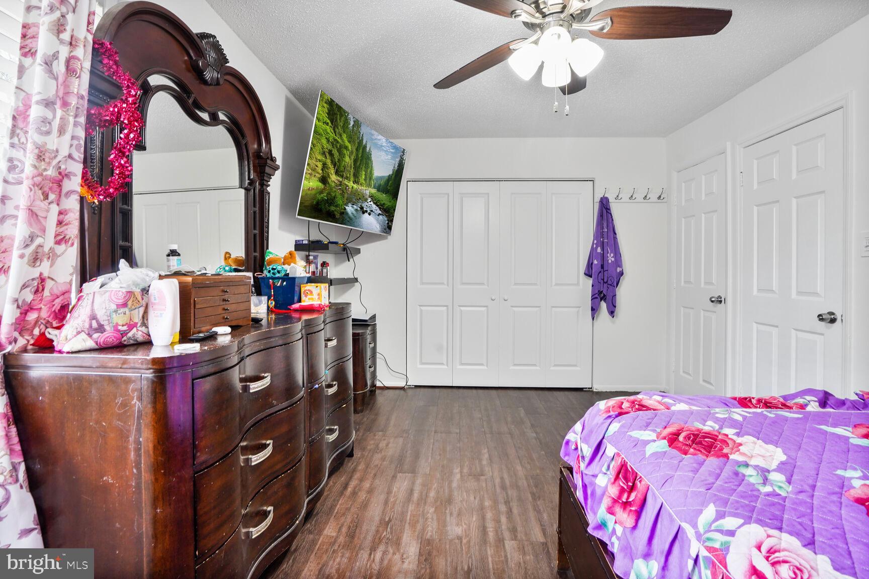 2412 Southgate Square Reston, VA 20191 - Photo 17 of 34 a bedroom with a bed and a chandelier