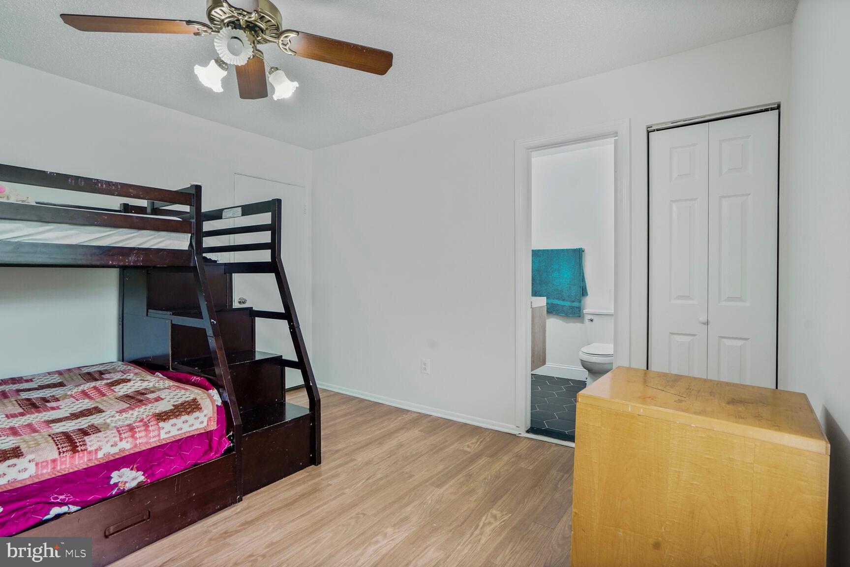 2412 Southgate Square Reston, VA 20191 - Photo 20 of 34 a bedroom with a bed and wooden floor