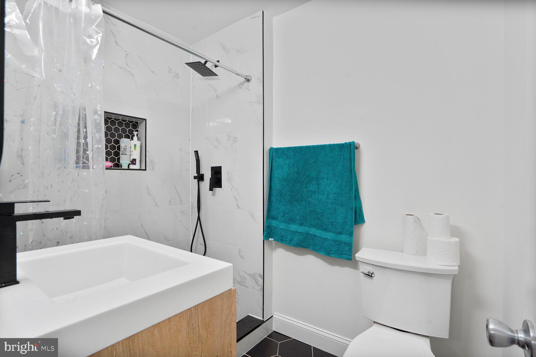 2412 Southgate Square Reston, VA 20191 - Photo 21 of 34 a bathroom with a sink a toilet and a shower