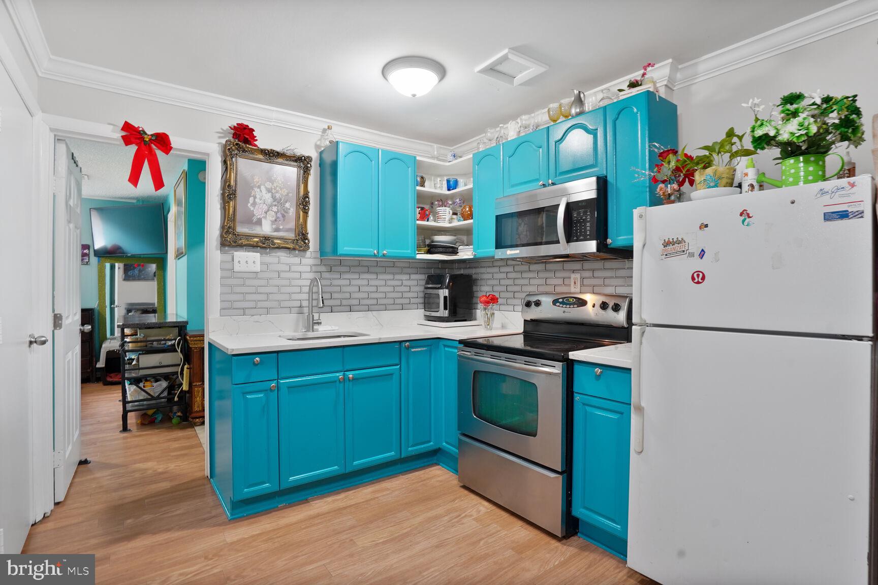 2412 Southgate Square Reston, VA 20191 - Photo 23 of 34 a kitchen with stainless steel appliances granite countertop a refrigerator sink microwave and cabinets