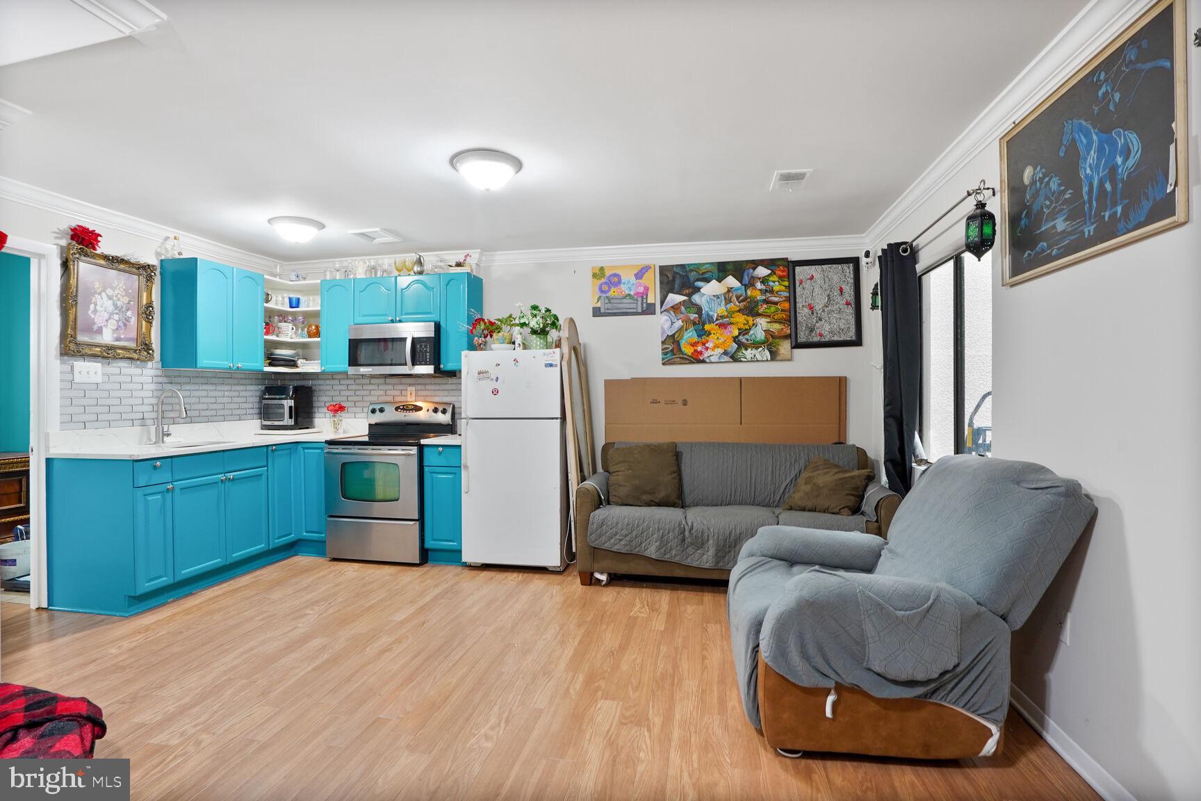 2412 Southgate Square Reston, VA 20191 - Photo 24 of 34 a kitchen with stainless steel appliances kitchen island granite countertop a refrigerator a sink dishwasher a dining table and chairs with wooden floor
