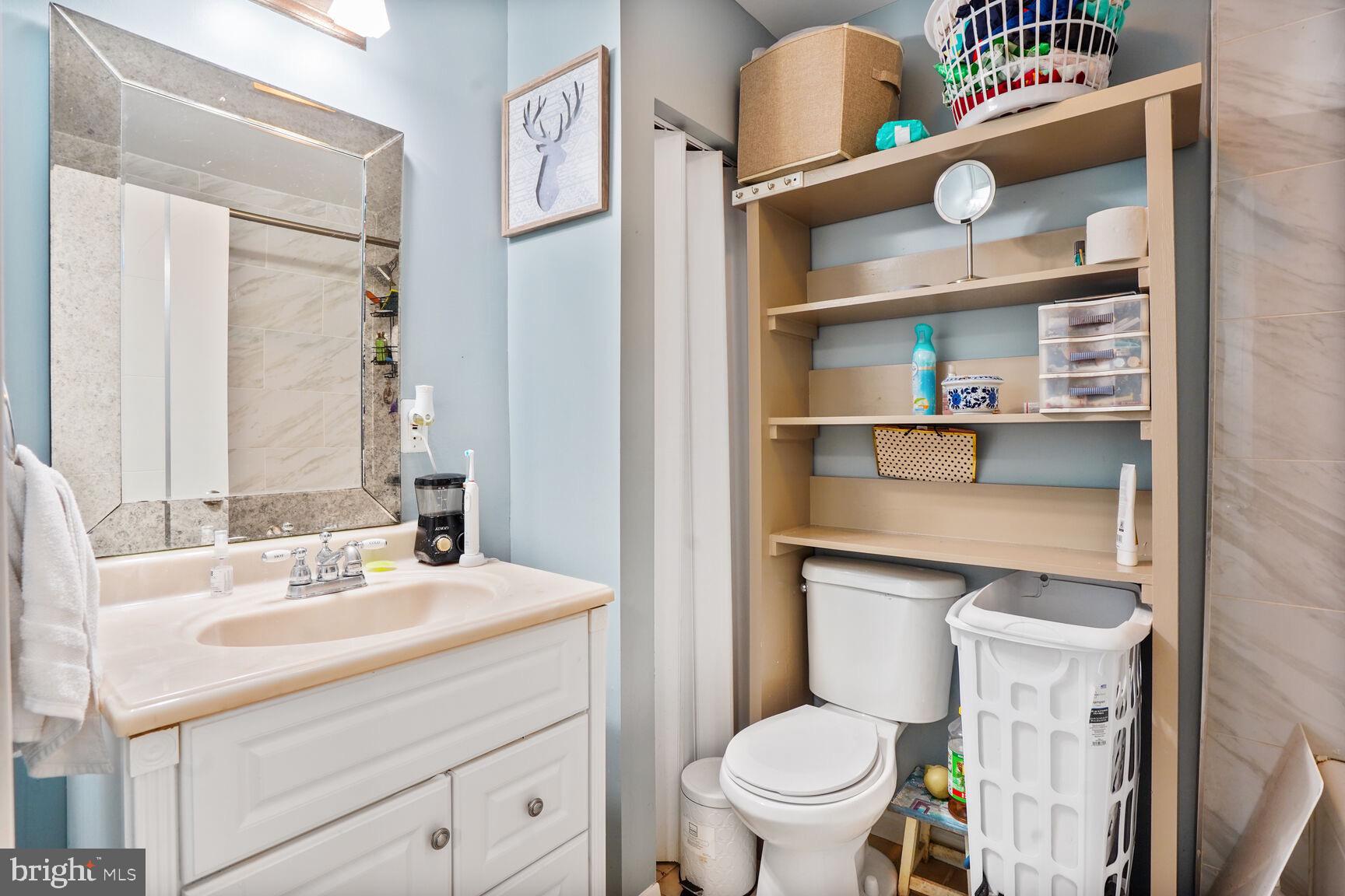 2412 Southgate Square Reston, VA 20191 - Photo 27 of 34 a bathroom with a sink a toilet and a mirror