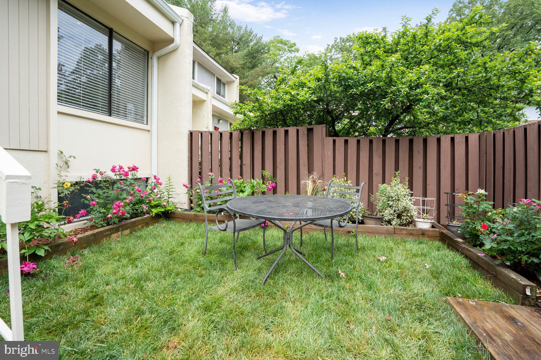 2412 Southgate Square Reston, VA 20191 - Photo 29 of 34 a view of a backyard with table and chairs and wooden fence