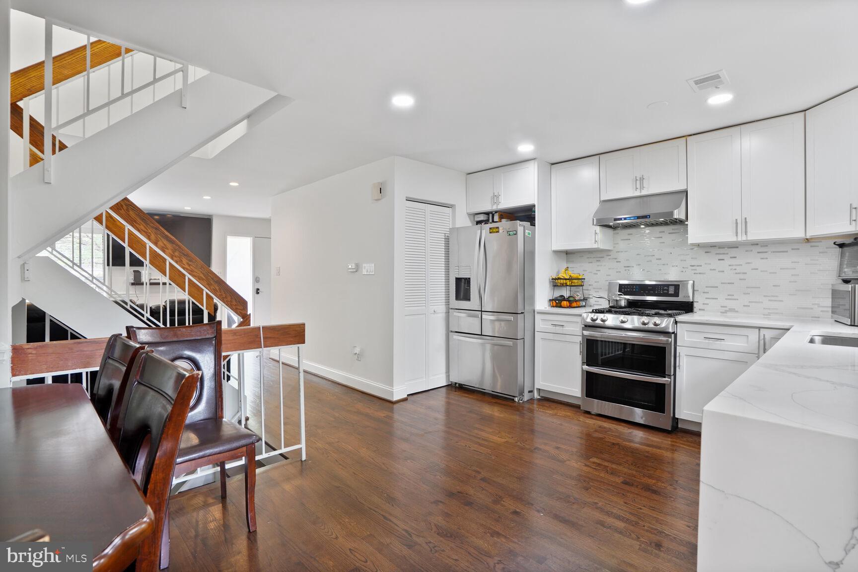 2412 Southgate Square Reston, VA 20191 - Photo 6 of 34 a kitchen with stainless steel appliances a stove a refrigerator and a refrigerator