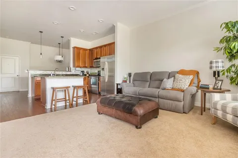 a living room with furniture and a kitchen view