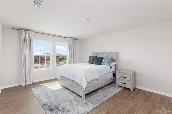 a bedroom with a large bed and a large window