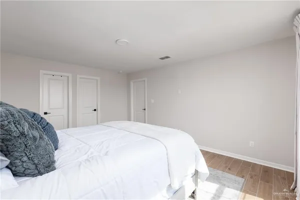 a bedroom with a bed and a white wall