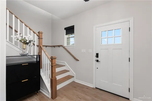 a view of entryway and hall with wooden floor