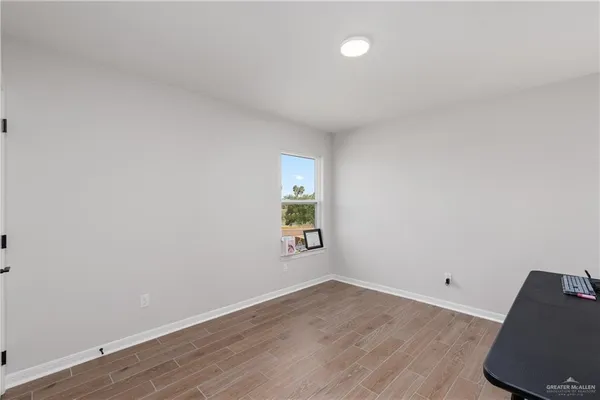 a view of room with wooden floor and window