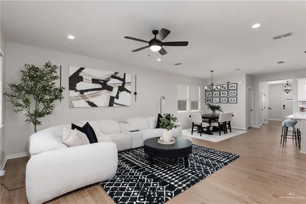 a living room with furniture and wooden floor