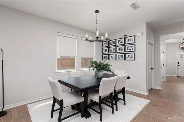 a view of a dining room with furniture and wooden floor