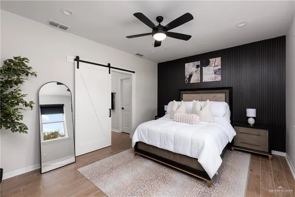 a bedroom with bed and a chandelier