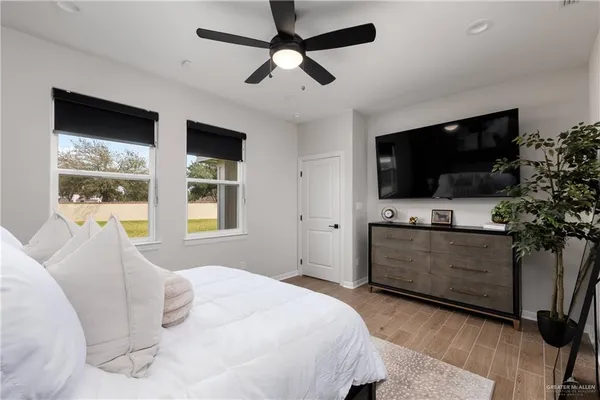 a bedroom with a bed and a flat screen tv