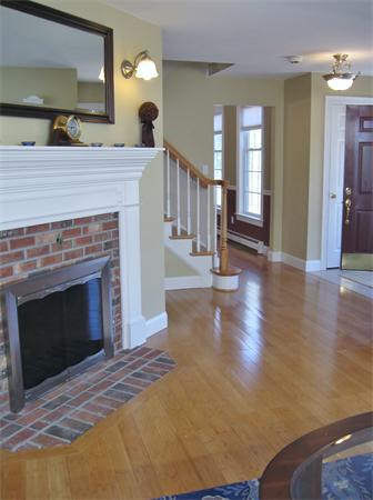 253 County Road Rochester, MA 02770 - Photo 3 of 30 a view of a livingroom with wooden floor and a fireplace