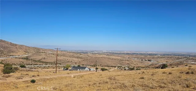 a view of a large building with mountains in the background