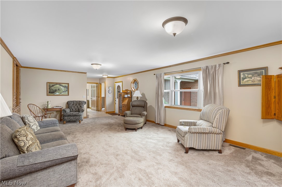 10909 Ruby Road Cambridge, OH 43725 - Photo 15 of 34 Carpeted living area featuring ornamental molding and baseboards