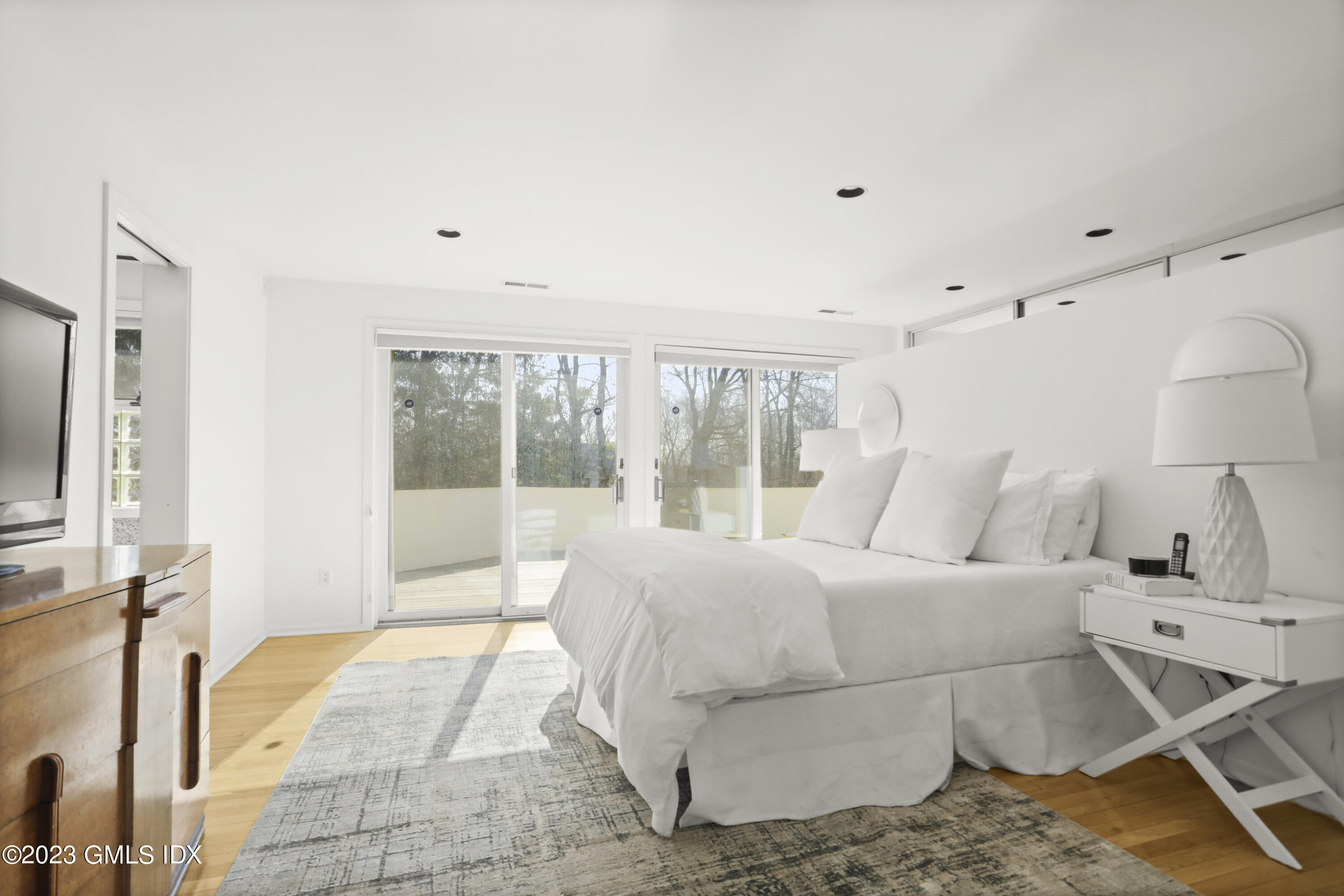 533 Cognewaugh Road Cos Cob, CT 06807 - Photo 11 of 21 a bed room with a bed and a night stand