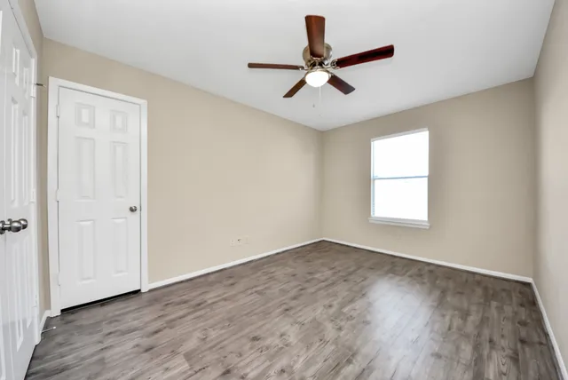 a bathroom with a granite countertop sink a toilet and shower