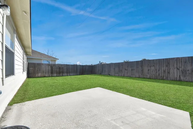 a view of a yard with a house in the background