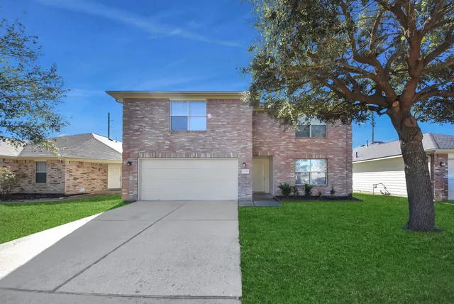 a view of a backyard with wooden fence