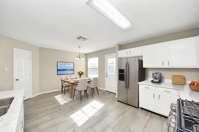 a view of a chandelier in big room and chandelier fan