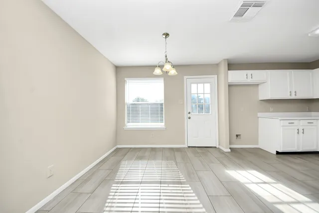 a kitchen with granite countertop white cabinets and white appliances